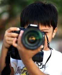 child taking picture